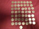 a lot of coins that are on a red cloth