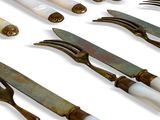 a lot of different types of knives and knives on the table