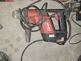 an image of a drill and other tools on the floor