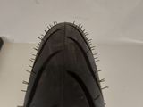 a close up of a bicycle tire on a white surface