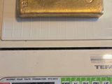 a gold bar sitting on top of a scale on a counter