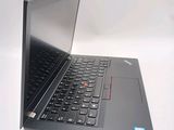 a laptop computer sitting on a table with a keyboard