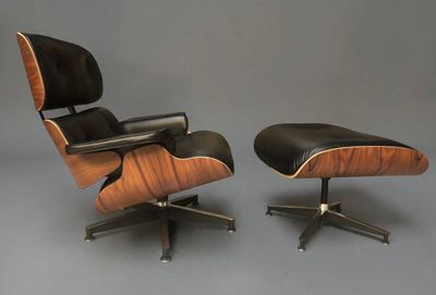 une paire de fauteuils Eames Lounge et un repose-pieds en cuir noir
