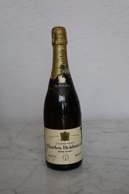 a bottle of champagne sitting on a marble table