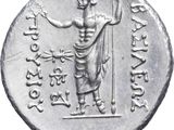 a close up of a silver coin with an image of a man holding a staff