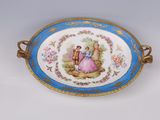 a blue and white plate with a picture of a man and a woman on it