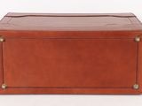 an old brown leather trunk with brass hardware on the sides