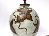 an image of a green vase with flowers on it