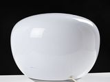 a white lamp that is sitting on a table