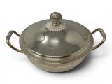 an antique silver plated casserole with a lid on a white background