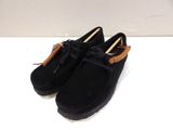 black sued shoes with a bow on the side of them