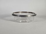a close up of a glass bowl with a silver rim