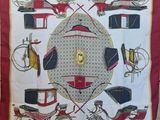a red and white scarf with a picture of a horse drawn carriage