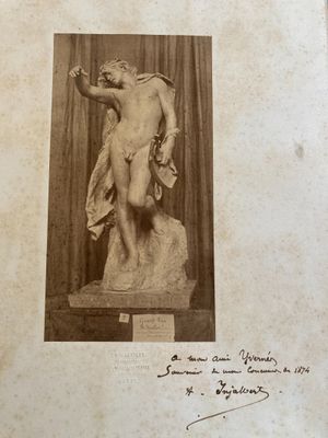 an old photo of a statue of a man on a pedestal