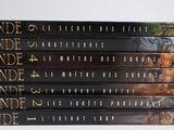 six books in a row on a white surface with a white background