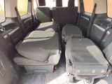 four seats in the back of a van with luggage in the back