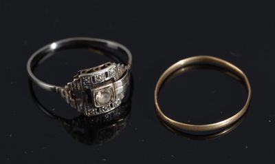 two rings are sitting next to each other on a black surface