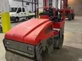 a large red machine that is parked in a building