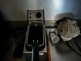 a coffee maker sitting on a kitchen counter next to a cup