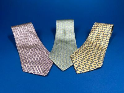 three different colored neck ties on a blue background