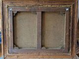 a close up of a picture frame on a table with a piece of cardboard