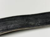 a close up of a knife on a white surface