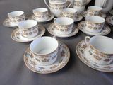 a lot of cups and saucers on the table
