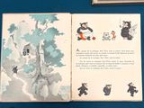 an open book with a picture of a bear and other animals on it