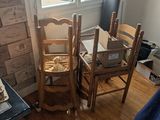 two chairs and a table in a room with boxes on the floor