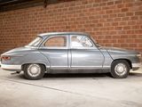 a silver car parked in a garage next to a brick wall