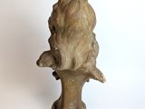 a statue of a bird perched on a tree branch