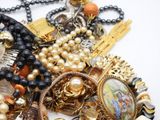 a pile of jewelry on a table with a white background