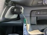 a car dashboard with a paper tag attached to it