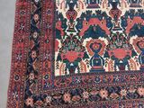 an antique persian rug with a blue and red design