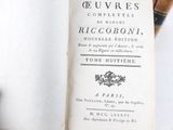 someone is holding a book open to a page that has a picture of a bird on it