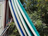 many surfboards stacked on top of each other in the back of a truck