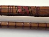 two baseball bats sitting next to each other on a table