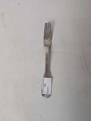 a fork with a tag on it sitting on a table