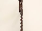 an old wooden stand with a bird on top of it on a white surface