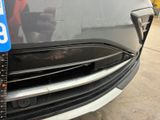 a close up of a car ' s front bumper with a number plate on it