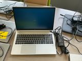 a laptop computer sitting on top of a wooden table