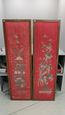 deux panneaux rouges ornés de motifs orientaux dans une pièce