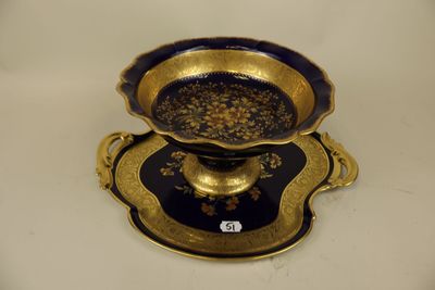 a blue and gold plate with a gold bowl on it