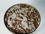 a brown and white table with a metal base