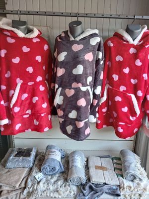 three women ' s pajamas are on display at a clothing store