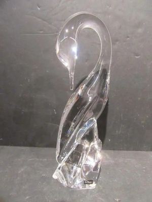 a glass swan figurine sitting on a table
