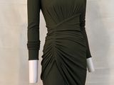 an image of a mannequin wearing a green dress on a white mannequin
