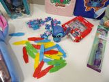 a lot of toothbrushes, toothpaste, toothbrushes, and other items on a table