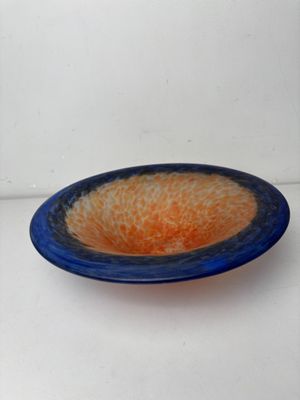 a blue and orange bowl sitting on a white surface