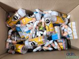 a cardboard box filled with many different types of toothpaste